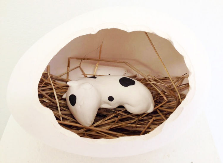 Sleeping baby cow in an egg